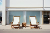 White deckchairs furniture outdoors window. 