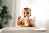 Holding milk bottle baby sitting refreshment. AI generated Image by rawpixel.