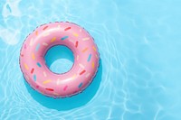 Cute donut swimming ring in a swimming pool inflatable confectionery recreation.