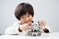 Asian cute boy smiling joyfully building a robot child smile happy. 