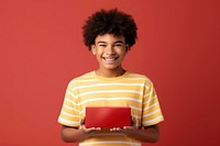 Teenage boy holding a burger box. AI generated Image by rawpixel.