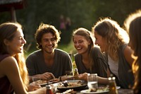 Eating laughing outdoors dinner. 