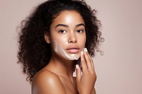 Half-affrican young woman skin portrait applying. AI generated Image by rawpixel.