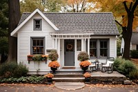 Cozy cottage with fall decorations porch architecture building. AI generated Image by rawpixel.