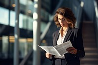 Business woman reading paperwork adult. AI generated Image by rawpixel.