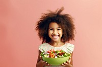 Kid girl eating salad smile child. 