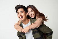 Young playful couple piggyback laughing smile adult. 