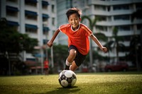 Boy playing football sports child transportation. AI generated Image by rawpixel.