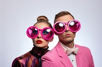 A couple wearing wierd party glasses sunglasses portrait purple. 