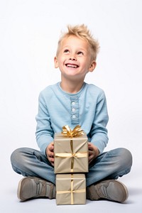 Holding gift boxes child sitting head. AI generated Image by rawpixel.