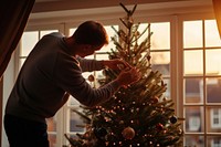 Chrimas tree decorating father photo. 