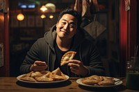 Korean man sitting eating bread. AI generated Image by rawpixel.