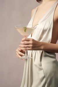 Martini cocktail holding drink glass. AI generated Image by rawpixel.