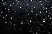 Water drops black backgrounds rain. AI generated Image by rawpixel.