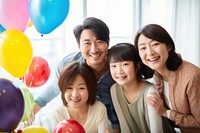 Happy mixed japanese family have dinner party birthday balloon. AI generated Image by rawpixel.