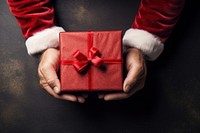 Santa Claus hand holding gift box. AI generated Image by rawpixel.