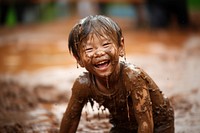 A little asian boy smile happy mud. 