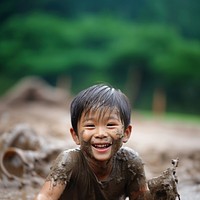 A little asian boy smile mud child. 