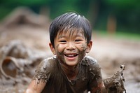 A little asian boy smile mud child. 