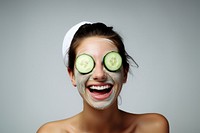 Woman has cucumber slice cover eye portrait smile photo. 