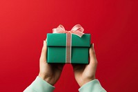 Christmas gift box holding hand celebration. AI generated Image by rawpixel.