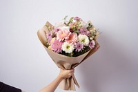 Hand holding luxury mixed flower bouquet plant paper rose. AI generated Image by rawpixel.