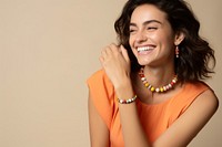 Woman wearing bracelet necklace laughing jewelry. AI generated Image by rawpixel.