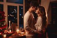 Young couple have romantic dinner christmas kissing candle. AI generated Image by rawpixel.