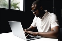 African American man laptop computer sitting. AI generated Image by rawpixel.