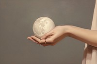 Moon hand holding sphere. 