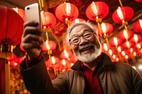 Chinese senior man selfie festival lantern. 