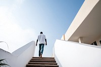 African american man walking architecture staircase. AI generated Image by rawpixel.
