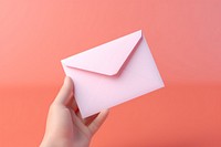 Hand holding envelope paper origami letter. AI generated Image by rawpixel.