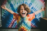 Kid wearing tie dye t-shirt shouting laughing child. AI generated Image by rawpixel.