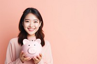 Piggy bank holding smile adult. AI generated Image by rawpixel.