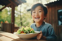 Salad eating smile child. AI generated Image by rawpixel.