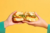 Egg sandwiches holding bread food. AI generated Image by rawpixel.