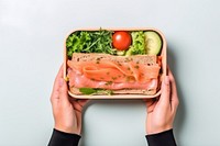 Lunch box seafood holding salmon. AI generated Image by rawpixel.
