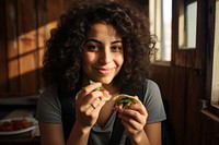 Middle eastern girl eating food portrait. AI generated Image by rawpixel.