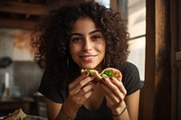 Middle eastern girl eating food biting. AI generated Image by rawpixel.