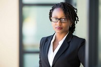 Female African American CEO glasses blazer office. 