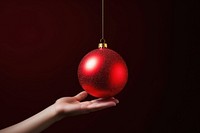Small christmas ball decoration hand red. AI generated Image by rawpixel.
