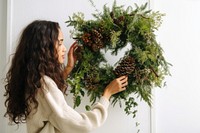 Christmas wreath plant adult woman. AI generated Image by rawpixel.