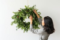Christmas wreath adult plant woman. AI generated Image by rawpixel.