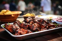 Glazed grilled chopped barbeque meat grilling outdoors cooking. 