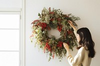 Adjust dried christmas wreath adult woman celebration. AI generated Image by rawpixel.