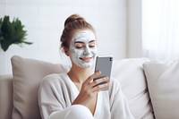 Woman wearing beauty face mask holding photo phone. AI generated Image by rawpixel.