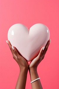 Hand holding big ceramic heart adult jewelry balloon. AI generated Image by rawpixel.