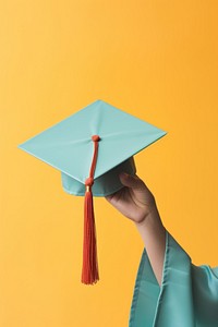 Hand holding graduation cap intelligence achievement mortarboard. 