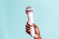 Hand holding microphone pink blue performance. AI generated Image by rawpixel.